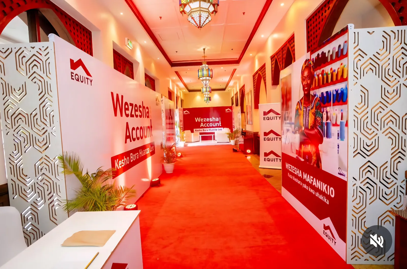 Branded event entrance with a red carpet and Equity Wezesha Account displays
